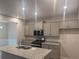 Modern kitchen features gray cabinets, granite countertops, stainless steel appliances, and a kitchen island at 1155 Park Center Cir, Austell, GA 30168