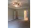 Spacious bedroom with a ceiling fan, tray ceilings, and entryways into a walk-in closet and bathroom at 1155 Park Center Cir, Austell, GA 30168