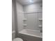 Bright shower and tub combo with shelving for storage at 1155 Park Center Cir, Austell, GA 30168