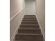Carpeted staircase leading upstairs to the next level of the house with white trim and neutral walls at 1155 Park Center Cir, Austell, GA 30168