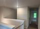 Upstairs hallway with views of the bedrooms and a window providing natural light at 1155 Park Center Cir, Austell, GA 30168