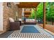 Covered back porch with outdoor seating and ceiling fan at 2024 Towneship Trl, Roswell, GA 30075