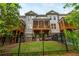 Rear view of townhome featuring multiple decks and fenced yard at 2024 Towneship Trl, Roswell, GA 30075
