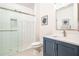 Modern bathroom featuring a subway tiled shower with glass door and blue vanity at 2024 Towneship Trl, Roswell, GA 30075