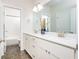 Bright bathroom with white cabinets, marble countertop, tile floors, and a separate toilet and shower area at 2024 Towneship Trl, Roswell, GA 30075