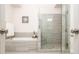 Modern bathroom featuring a walk-in shower, soaking tub, and elegant gray tiling at 2024 Towneship Trl, Roswell, GA 30075