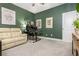 Comfortable bedroom featuring green walls, a plush sofa, and modern artwork, ideal for relaxation and productivity at 2024 Towneship Trl, Roswell, GA 30075