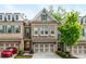 Charming brick townhome featuring a two-car garage and manicured landscaping at 2024 Towneship Trl, Roswell, GA 30075