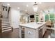 Open concept kitchen with island, stainless steel appliances, and hardwood floors at 2024 Towneship Trl, Roswell, GA 30075