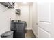 Laundry room with washer, dryer, built-in storage, and tiled floor at 2024 Towneship Trl, Roswell, GA 30075