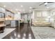 Open-concept living room with hardwood floors, modern kitchen, and cozy seating area, perfect for entertaining at 2024 Towneship Trl, Roswell, GA 30075