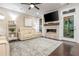Bright living room with stone fireplace, hardwood floors, and access to a porch at 2024 Towneship Trl, Roswell, GA 30075