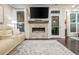 Bright living room with stone fireplace, hardwood floors, and access to outdoor spaces at 2024 Towneship Trl, Roswell, GA 30075