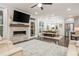 Open living room with fireplace flows into the kitchen and dining area at 2024 Towneship Trl, Roswell, GA 30075