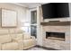Comfortable living room featuring a modern fireplace, large windows, and a cozy couch at 2024 Towneship Trl, Roswell, GA 30075
