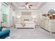 Main bedroom features tray ceiling, large windows, and comfortable furnishings at 2024 Towneship Trl, Roswell, GA 30075