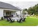 Backyard area with a fire pit, outdoor kitchen, dining area and mini golf at 210 Mooney Rd, Woodstock, GA 30188