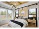 Stylish bedroom with a wood-paneled ceiling, modern chandelier, and large windows for ample natural light at 210 Mooney Rd, Woodstock, GA 30188
