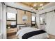 Chic bedroom features a unique wood ceiling, designer lighting, and an attached bathroom for added convenience at 210 Mooney Rd, Woodstock, GA 30188