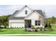 Charming two-story home features a well-manicured lawn, crisp white siding, and an attached two-car garage at 210 Mooney Rd, Woodstock, GA 30188