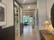 Bright hallway with hardwood floors leads to an open-concept living area, with light wood and recessed lighting at 210 Mooney Rd, Woodstock, GA 30188