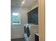 Efficient laundry room features a washer and dryer and upper cabinets for optimal storage solutions at 210 Mooney Rd, Woodstock, GA 30188