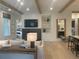Living room with built-in shelving, modern lighting, and an open view to the kitchen, creating a welcoming space at 210 Mooney Rd, Woodstock, GA 30188