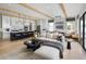 Spacious kitchen, dining, and living area featuring exposed beams and light hardwood floors with a modern, open design at 210 Mooney Rd, Woodstock, GA 30188