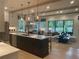 Open floor plan with large kitchen island, integrated dining area, and a spacious living room with exposed beams at 210 Mooney Rd, Woodstock, GA 30188