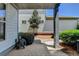 View of the brick patio surrounded by lush bushes and a young tree in the backyard at 375 Causeway Ct, Suwanee, GA 30024