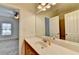 Bathroom featuring a vanity with cabinets, a large mirror, and an open doorway to another room at 375 Causeway Ct, Suwanee, GA 30024