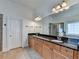 A beautifully appointed bathroom with a double vanity with granite countertop, large mirror, and lighting at 375 Causeway Ct, Suwanee, GA 30024