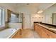 Spacious bathroom features double vanity, granite countertop, shower, and large soaking tub at 375 Causeway Ct, Suwanee, GA 30024