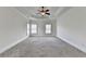 A spacious bedroom with carpet flooring, two windows, and decorative ceiling trim at 375 Causeway Ct, Suwanee, GA 30024