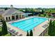 Aerial view of the community pool with lounge chairs, umbrellas, and lush landscaping at 375 Causeway Ct, Suwanee, GA 30024