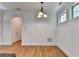 Bright dining area featuring hardwood floors, modern lighting fixture, and two windows for natural light at 375 Causeway Ct, Suwanee, GA 30024