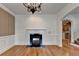 Dining room with hardwood floors, chandelier, fireplace and archway to the kitchen at 375 Causeway Ct, Suwanee, GA 30024