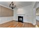 Dining room featuring hardwood floors, chandelier, fireplace and wainscoting at 375 Causeway Ct, Suwanee, GA 30024