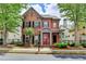 Charming two-story brick home featuring a red door and beautifully landscaped front yard at 375 Causeway Ct, Suwanee, GA 30024