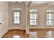 Bright foyer with hardwood floors, transom window door, and large arched windows at 375 Causeway Ct, Suwanee, GA 30024
