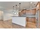 Modern kitchen with a spacious island, granite countertops, and stainless steel appliances at 375 Causeway Ct, Suwanee, GA 30024