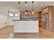 Modern kitchen featuring an island, granite countertops, pendant lighting, and stainless steel appliances at 375 Causeway Ct, Suwanee, GA 30024