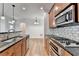 Gourmet kitchen with stainless steel appliances and tile backsplash at 375 Causeway Ct, Suwanee, GA 30024