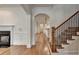 Open-concept living room showcasing hardwood floors, fireplace, and archway to the kitchen at 375 Causeway Ct, Suwanee, GA 30024