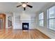 Inviting living room with hardwood floors, fireplace, built-in shelving, and large windows with wooden blinds at 375 Causeway Ct, Suwanee, GA 30024