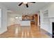 Bright living room with hardwood floors adjacent to a kitchen, offering an open and airy feel at 375 Causeway Ct, Suwanee, GA 30024