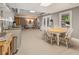 Open basement with a kitchen area, dining space, and living space with natural light at 420 Windswept Ct, Roswell, GA 30075