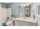 Well-lit bathroom featuring a classic vanity, large mirror, and a shower-tub combination for convenience at 420 Windswept Ct, Roswell, GA 30075