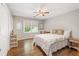 Cozy bedroom with hardwood floors, a ceiling fan, and natural light provides a peaceful retreat at 420 Windswept Ct, Roswell, GA 30075
