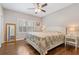 Cozy bedroom with hardwood floors, a ceiling fan, and a comfortable bed at 420 Windswept Ct, Roswell, GA 30075
